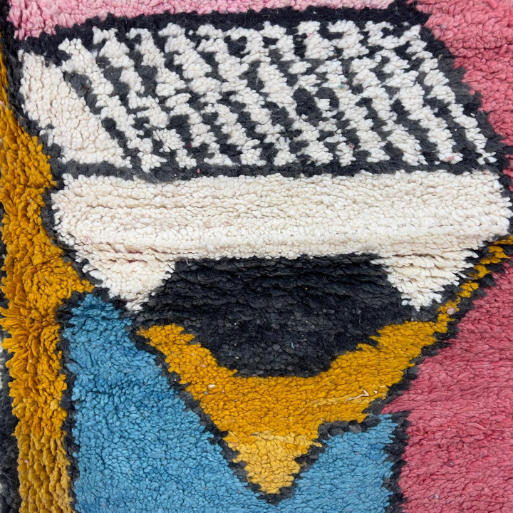 Vintage Moroccan wool rug 8.5 x 5.1 ft with abstract human figures design in pink blue and cream handmade Berber rug