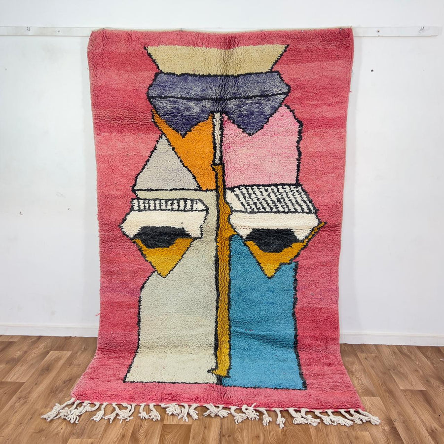 Vintage Moroccan wool rug 8.5 x 5.1 ft with abstract human figures design in pink blue and cream handmade Berber rug