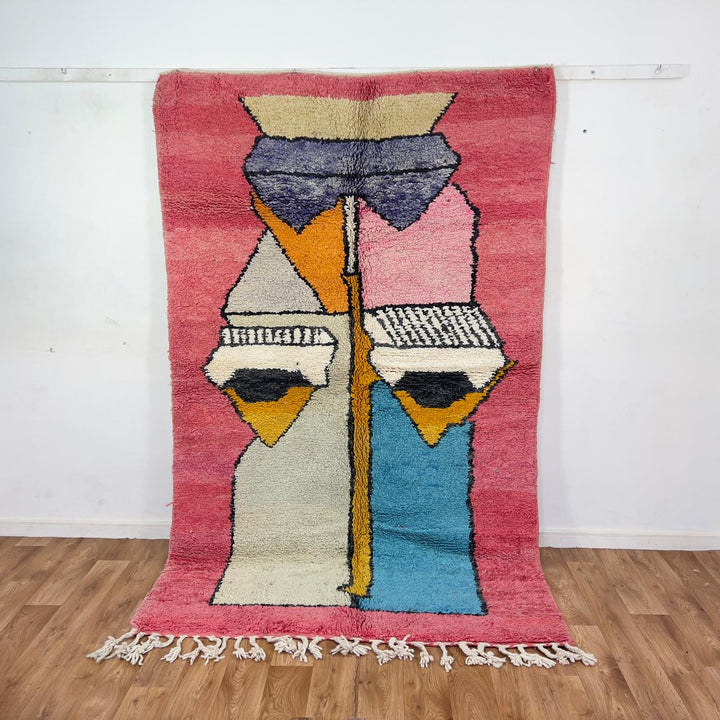 Vintage Moroccan wool rug 8.5 x 5.1 ft with abstract human figures design in pink blue and cream handmade Berber rug