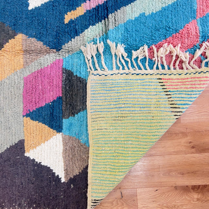 Vintage Moroccan wool rug with geometric abstract pattern in blue, pink and neutral tones, handmade Berber rug