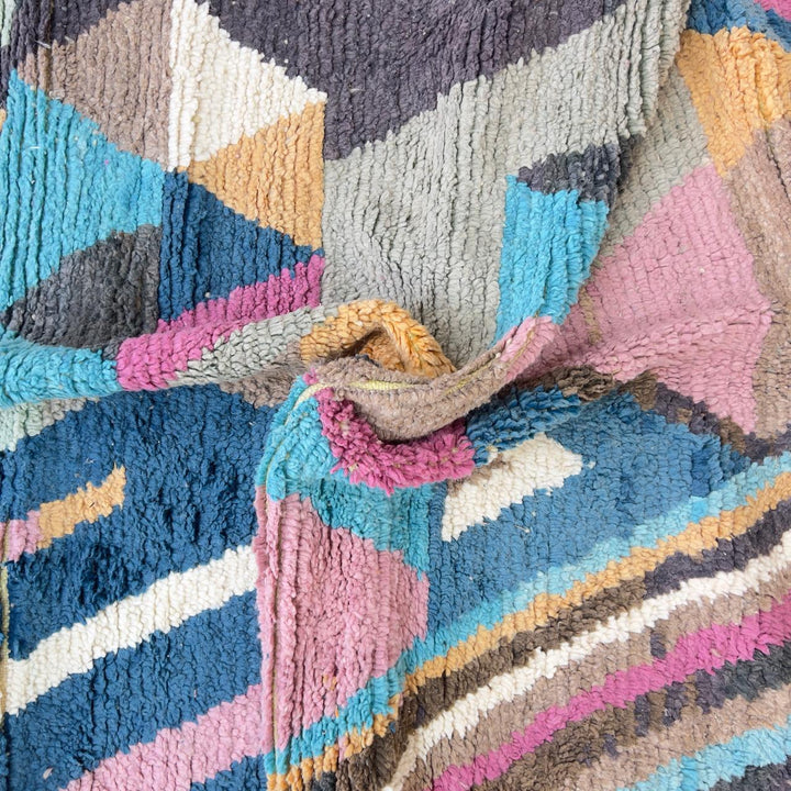 Vintage Moroccan wool rug with geometric abstract pattern in blue, pink and neutral tones, handmade Berber rug