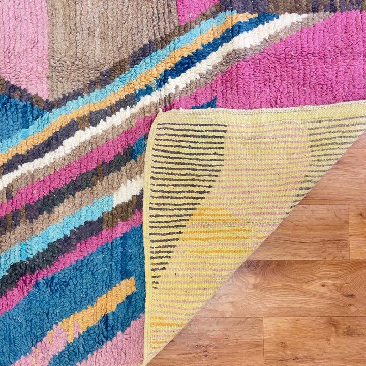 Vintage Moroccan wool rug with geometric abstract pattern in blue, pink and neutral tones, handmade Berber rug