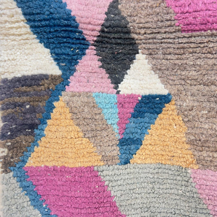 Vintage Moroccan wool rug with geometric abstract pattern in blue, pink and neutral tones, handmade Berber rug