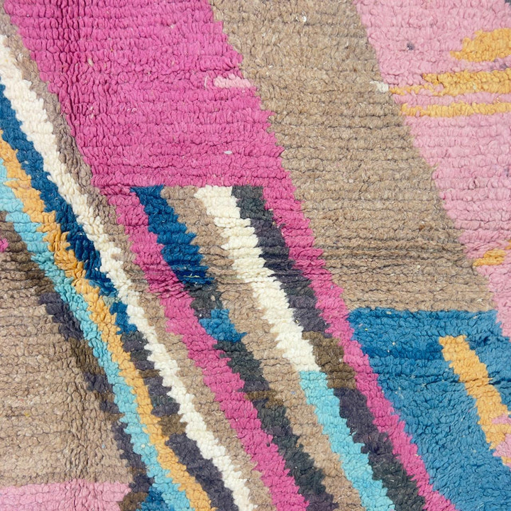 Vintage Moroccan wool rug with geometric abstract pattern in blue, pink and neutral tones, handmade Berber rug