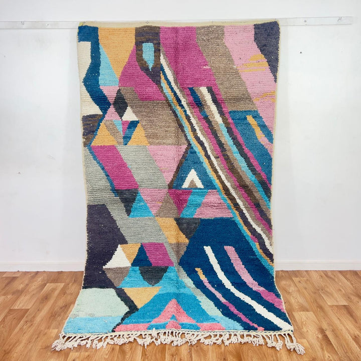 Vintage Moroccan wool rug with geometric abstract pattern in blue, pink and neutral tones, handmade Berber rug