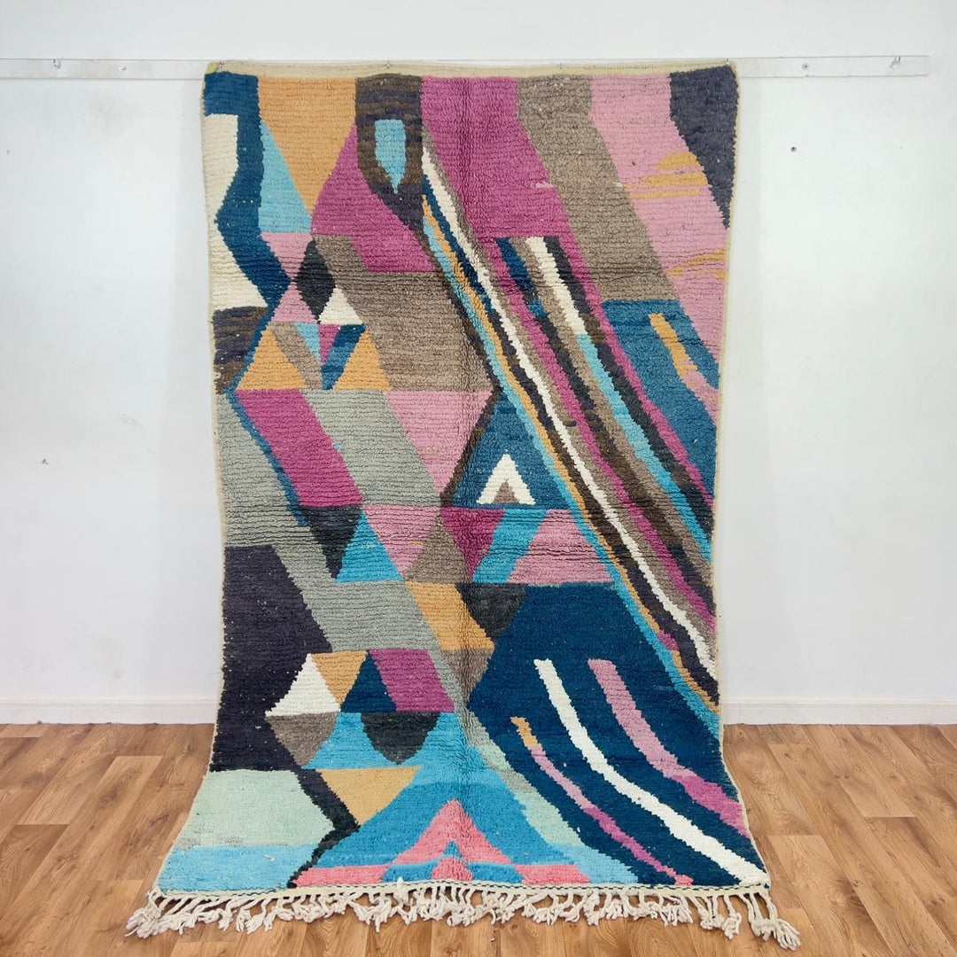 Vintage Moroccan wool rug with geometric abstract pattern in blue, pink and neutral tones, handmade Berber rug