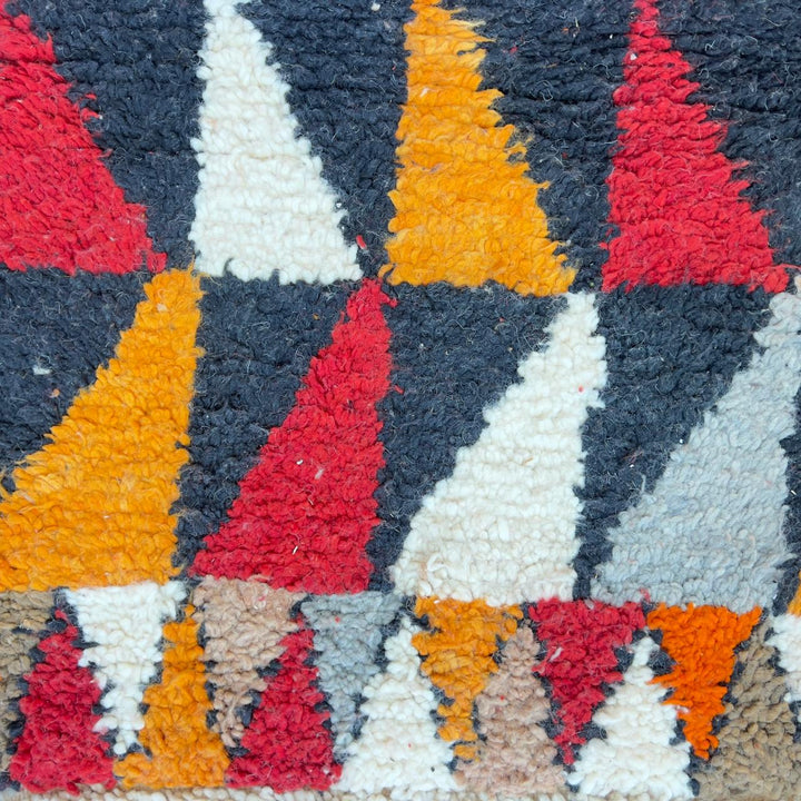 Vintage Moroccan wool rug with colorful geometric diamond and tribal patterns in red, orange and neutral tones, handmade Berber rug