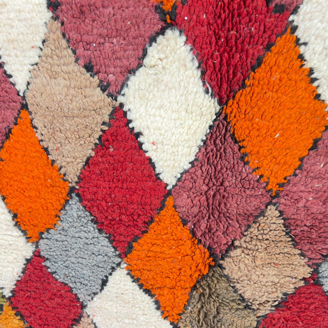Vintage Moroccan wool rug with colorful geometric diamond and tribal patterns in red, orange and neutral tones, handmade Berber rug