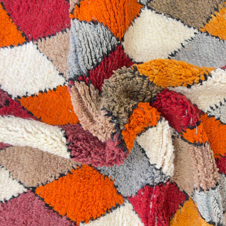 Vintage Moroccan wool rug with colorful geometric diamond and tribal patterns in red, orange and neutral tones, handmade Berber rug