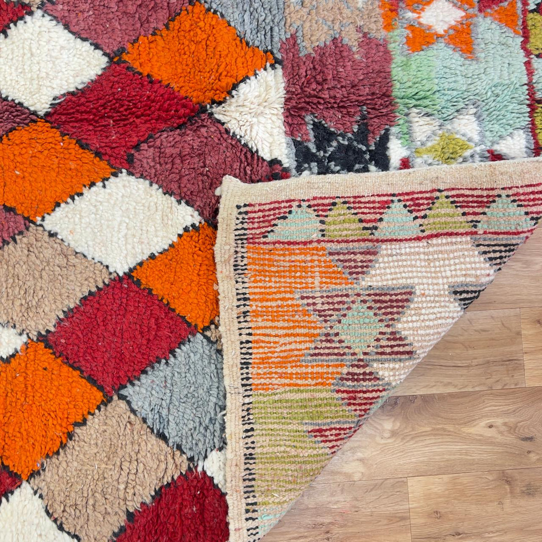 Vintage Moroccan wool rug with colorful geometric diamond and tribal patterns in red, orange and neutral tones, handmade Berber rug