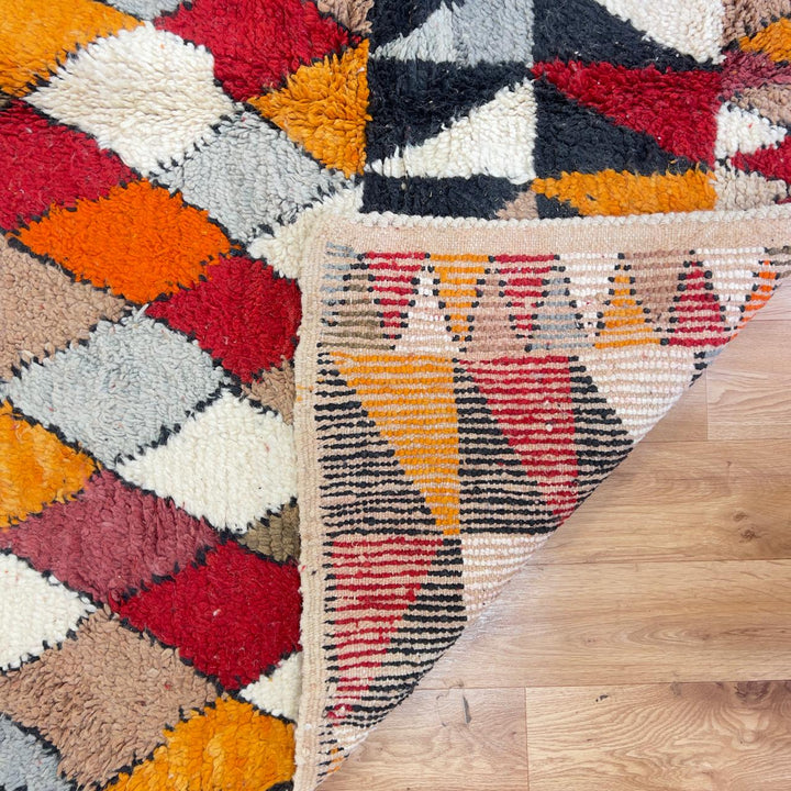 Vintage Moroccan wool rug with colorful geometric diamond and tribal patterns in red, orange and neutral tones, handmade Berber rug