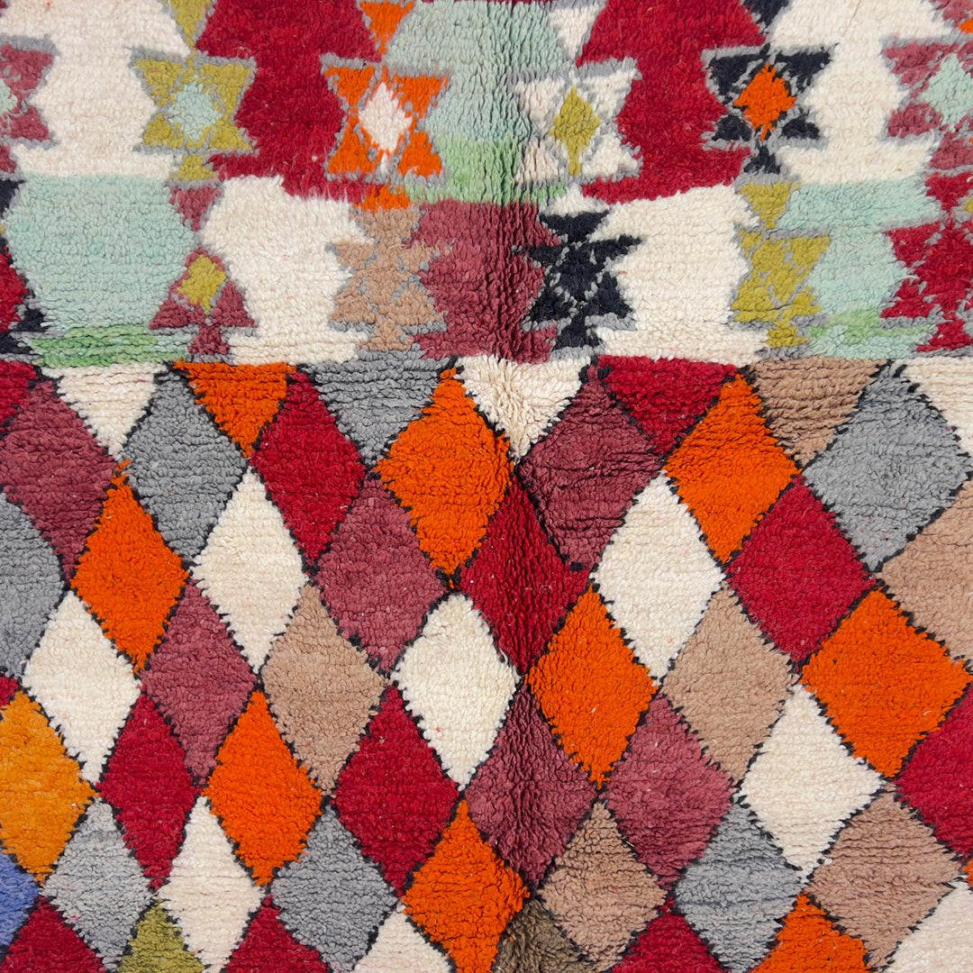 Vintage Moroccan wool rug with colorful geometric diamond and tribal patterns in red, orange and neutral tones, handmade Berber rug