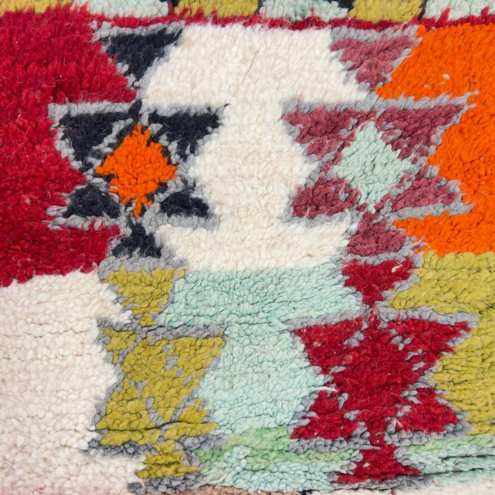 Vintage Moroccan wool rug with colorful geometric diamond and tribal patterns in red, orange and neutral tones, handmade Berber rug