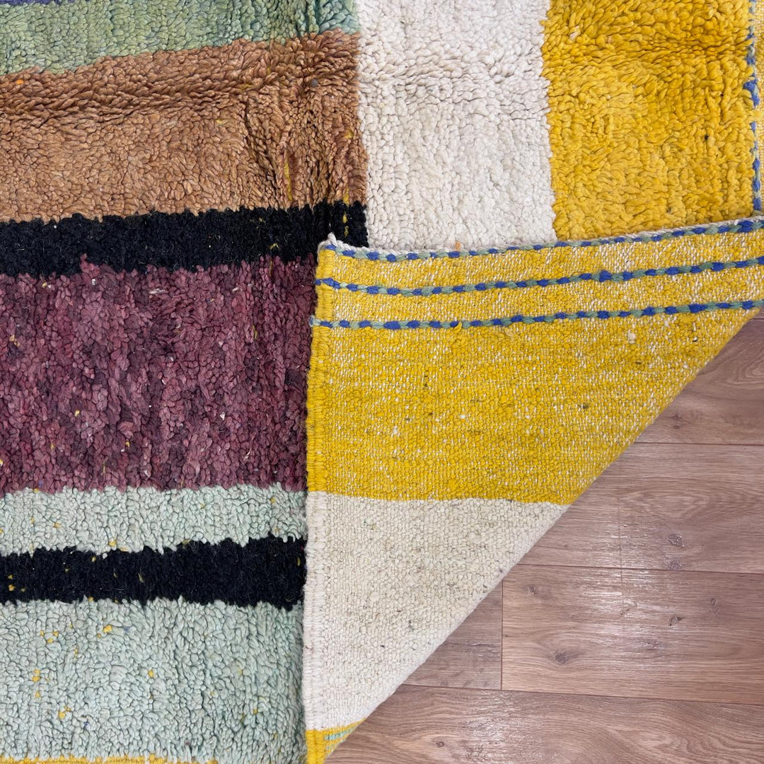Vintage Moroccan wool rug 8.46 x 5.38 ft with abstract geometric design in blue yellow green and cream handmade Berber rug
