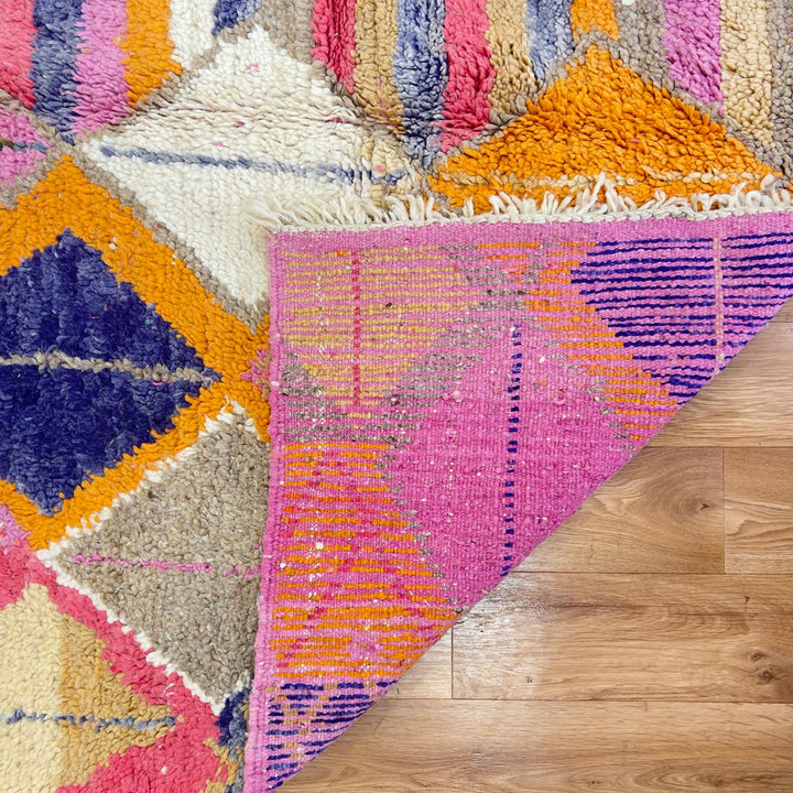Vintage Moroccan wool rug with colorful geometric diamonds and striped pattern in pink, orange and purple tones, handmade Berber rug