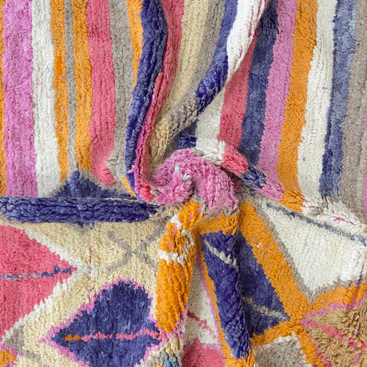 Vintage Moroccan wool rug with colorful geometric diamonds and striped pattern in pink, orange and purple tones, handmade Berber rug