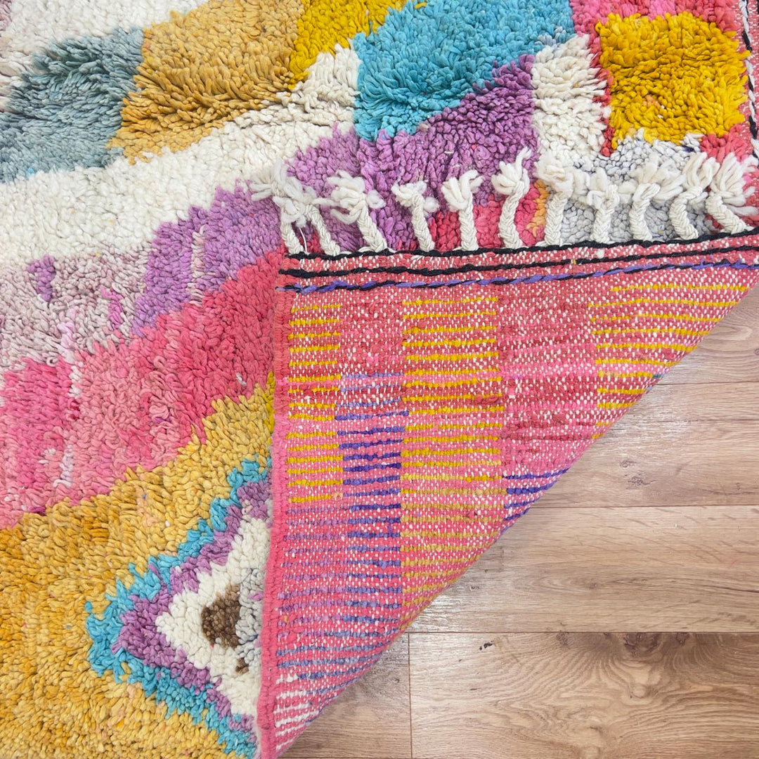 Vintage Moroccan wool rug with colorful abstract design in pink, yellow, blue and cream tones, handmade Berber rug