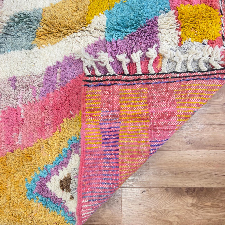 Vintage Moroccan wool rug with colorful abstract design in pink, yellow, blue and cream tones, handmade Berber rug