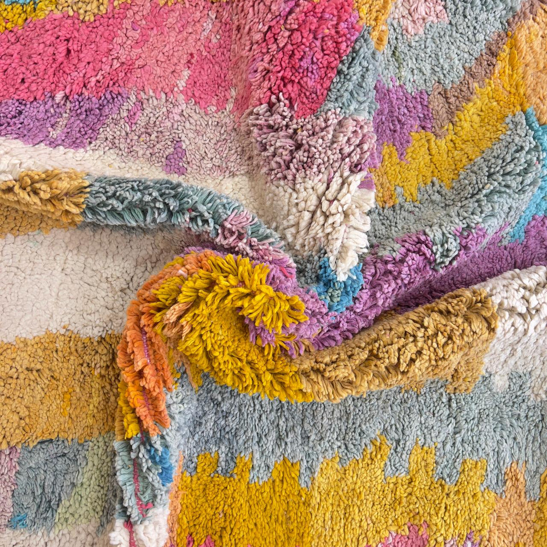 Vintage Moroccan wool rug with colorful abstract design in pink, yellow, blue and cream tones, handmade Berber rug