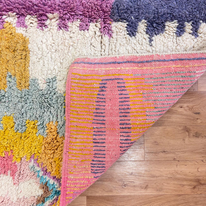 Vintage Moroccan wool rug with colorful abstract design in pink, yellow, blue and cream tones, handmade Berber rug