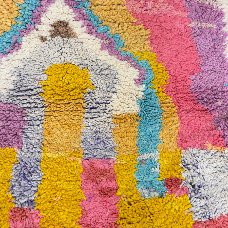 Vintage Moroccan wool rug with colorful abstract design in pink, yellow, blue and cream tones, handmade Berber rug
