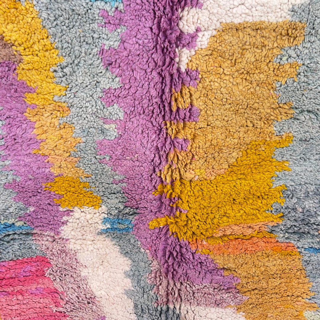 Vintage Moroccan wool rug with colorful abstract design in pink, yellow, blue and cream tones, handmade Berber rug