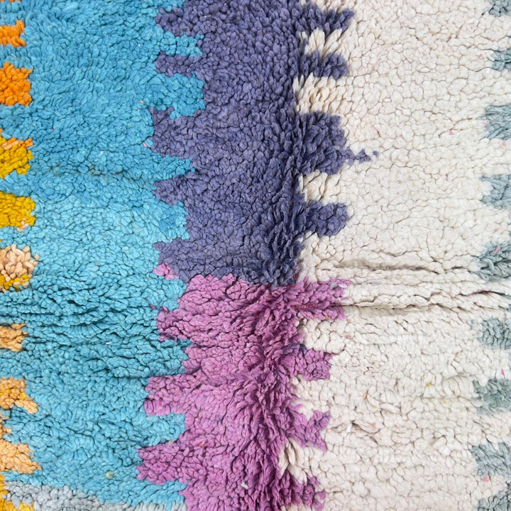 Vintage Moroccan wool rug with colorful abstract design in pink, yellow, blue and cream tones, handmade Berber rug