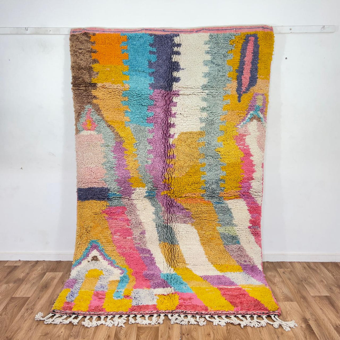 Vintage Moroccan wool rug with colorful abstract design in pink, yellow, blue and cream tones, handmade Berber rug