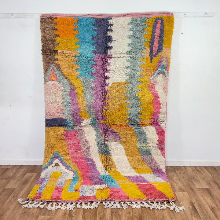 Vintage Moroccan wool rug with colorful abstract design in pink, yellow, blue and cream tones, handmade Berber rug