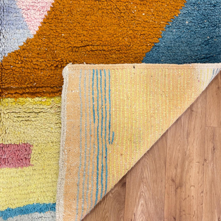 Vintage Moroccan wool rug with pastel geometric design in blue, pink, yellow and neutral tones, handmade Berber rug