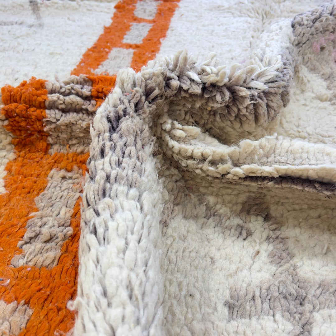 Vintage Moroccan wool rug with ivory base and orange tribal accents handmade Berber minimalist rug