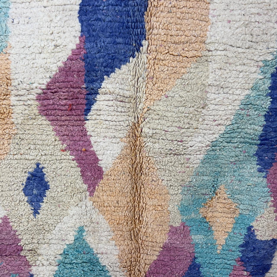 Vintage Moroccan wool rug 8.20 x 5.38 ft Rug 76 with abstract pastel design in pink, mint green, beige and blue tones, handmade Berber rug displayed on wooden floor