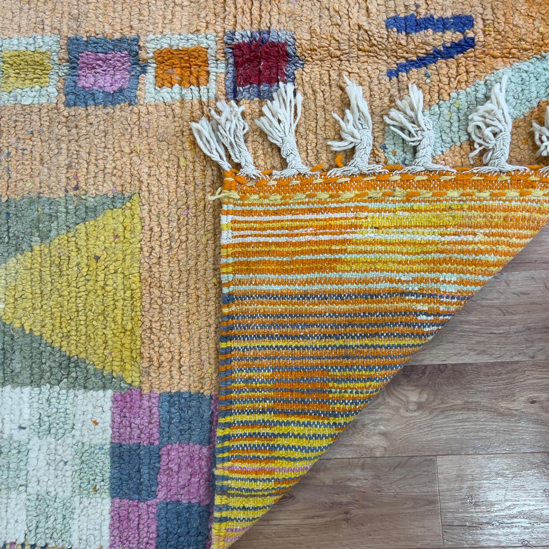 Vintage Moroccan wool rug 8.0 x 5.4 ft with orange background and geometric Berber symbols in yellow purple and cream handmade rug