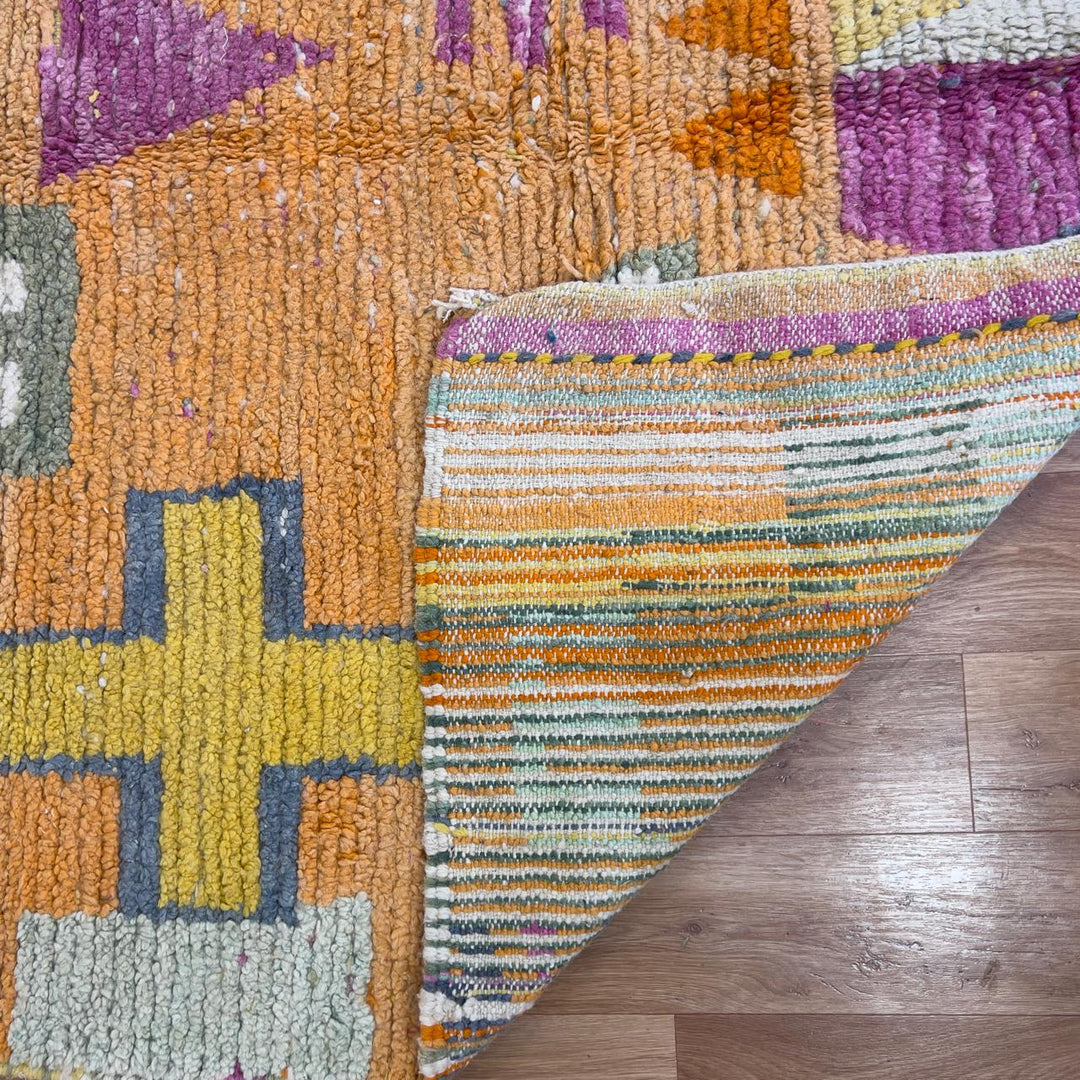 Vintage Moroccan wool rug 8.0 x 5.4 ft with orange background and geometric Berber symbols in yellow purple and cream handmade rug