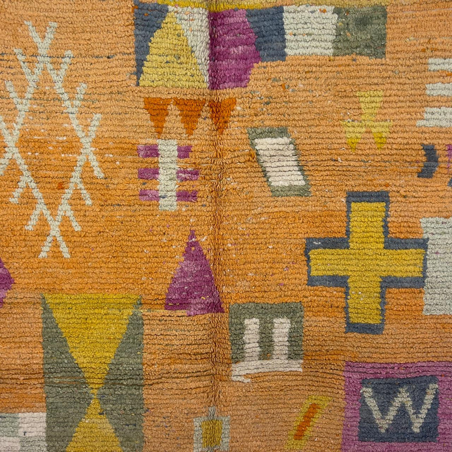 Vintage Moroccan wool rug 8.0 x 5.4 ft with orange background and geometric Berber symbols in yellow purple and cream handmade rug