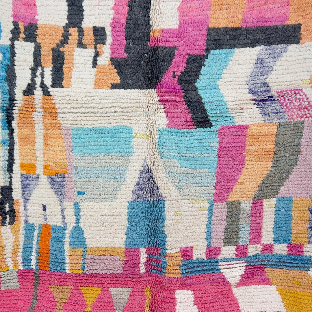 Vintage Moroccan wool rug with abstract geometric patterns in pink, blue, and yellow tones