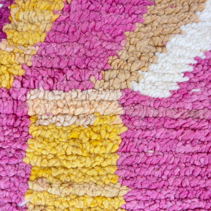 Vintage Moroccan wool rug with abstract geometric patterns in pink, blue, and yellow tones