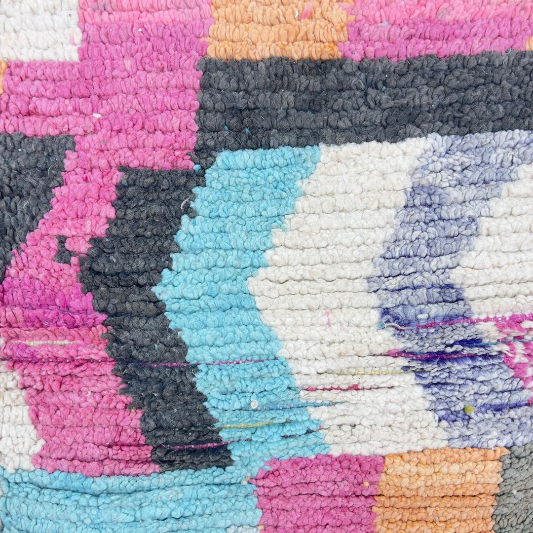 Vintage Moroccan wool rug with abstract geometric patterns in pink, blue, and yellow tones