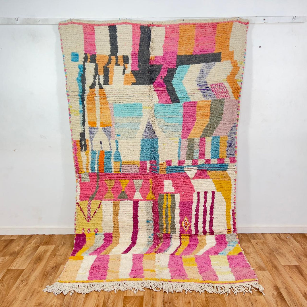 Vintage Moroccan wool rug with abstract geometric patterns in pink, blue, and yellow tones