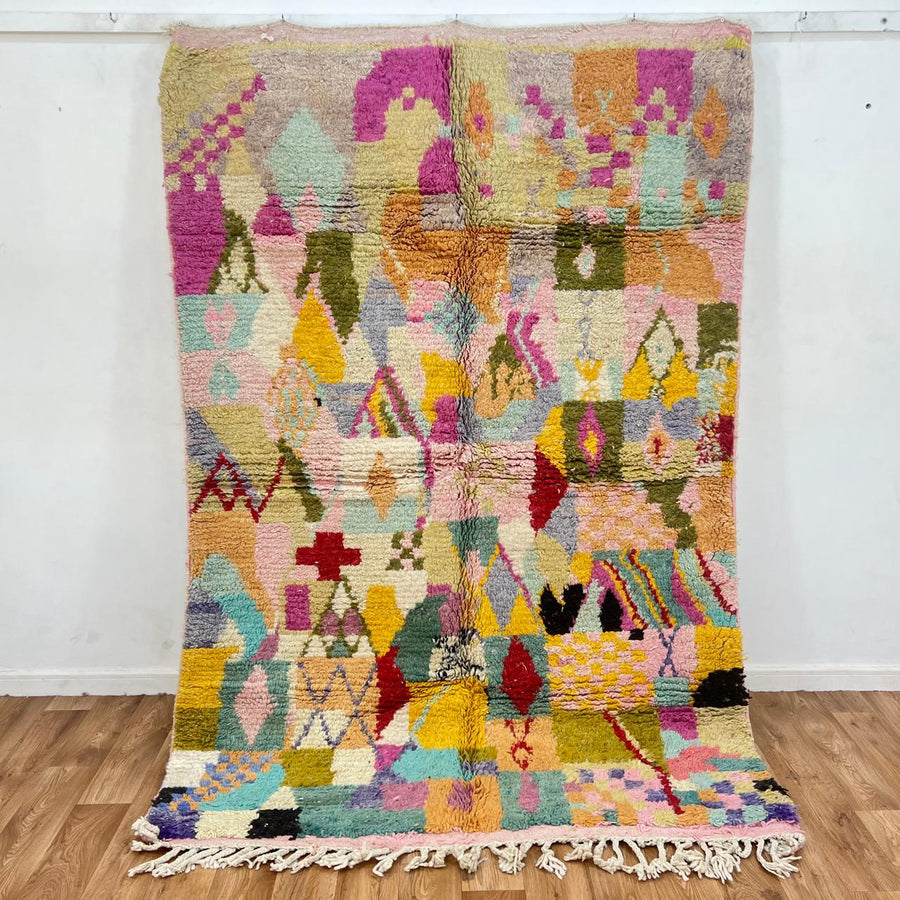 Vintage Moroccan wool rug with colorful Berber geometric patterns, handmade in Morocco.
