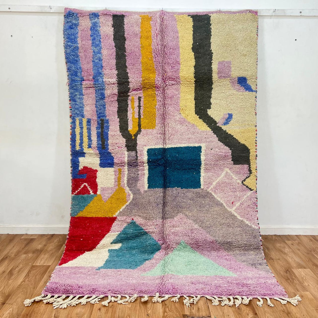 Vintage Moroccan wool rug with abstract Berber geometric shapes in blush pink, teal, mustard and ivory, handmade in Morocco.