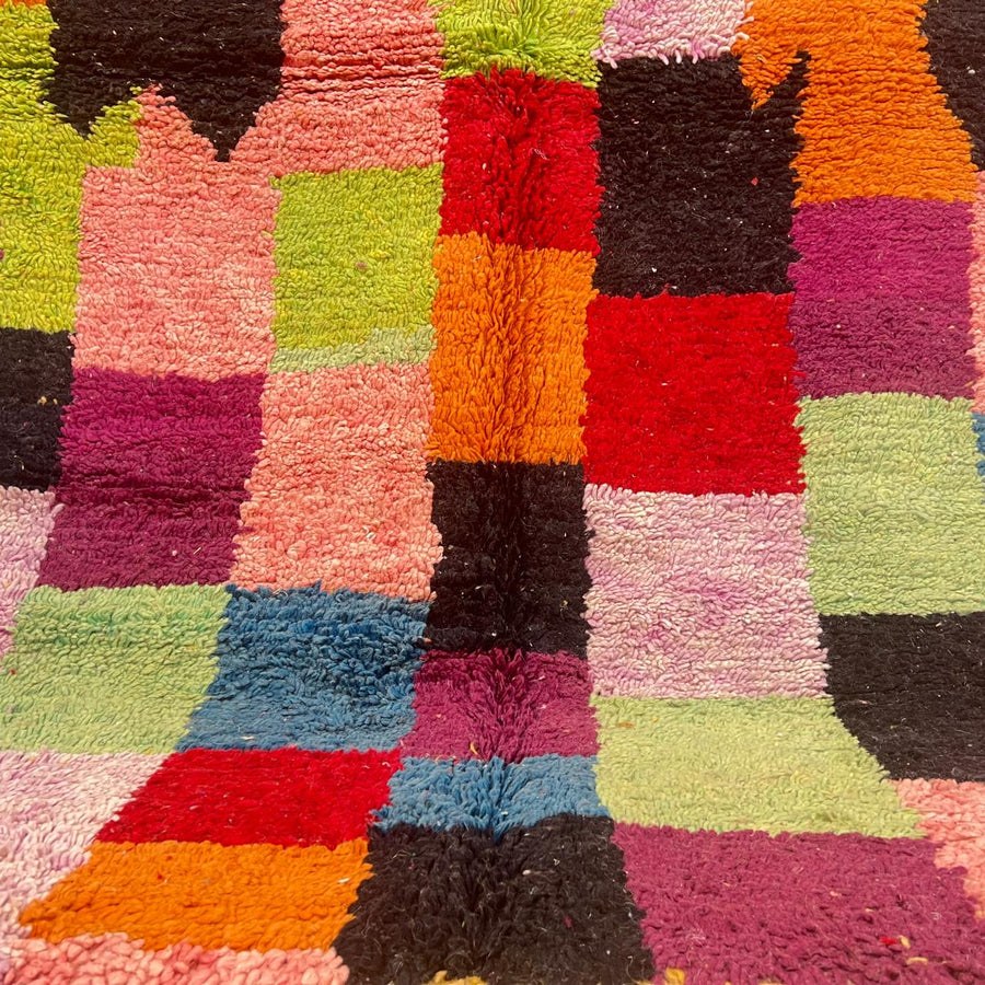 Vintage Moroccan wool rug with colorful Berber patchwork blocks and central diamond motif, handmade in Morocco.