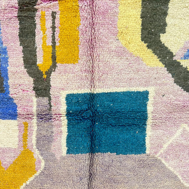 Vintage Moroccan wool rug with abstract Berber geometric shapes in blush pink, teal, mustard and ivory, handmade in Morocco.