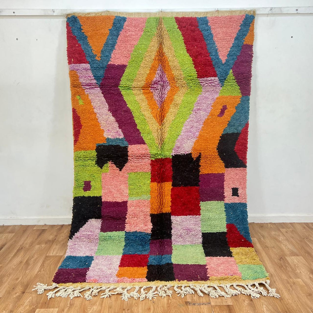 Vintage Moroccan wool rug with colorful Berber patchwork blocks and central diamond motif, handmade in Morocco.