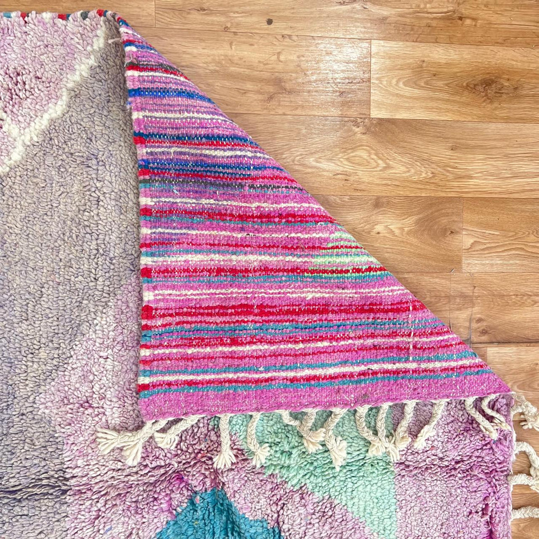 Vintage Moroccan wool rug with abstract Berber geometric shapes in blush pink, teal, mustard and ivory, handmade in Morocco.