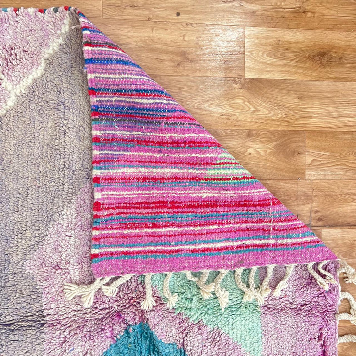 Vintage Moroccan wool rug with abstract Berber geometric shapes in blush pink, teal, mustard and ivory, handmade in Morocco.
