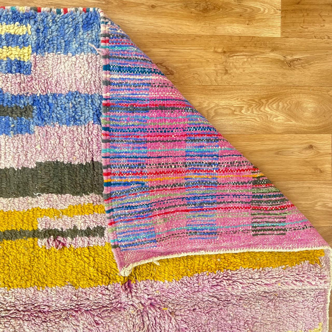 Vintage Moroccan wool rug with abstract Berber geometric shapes in blush pink, teal, mustard and ivory, handmade in Morocco.