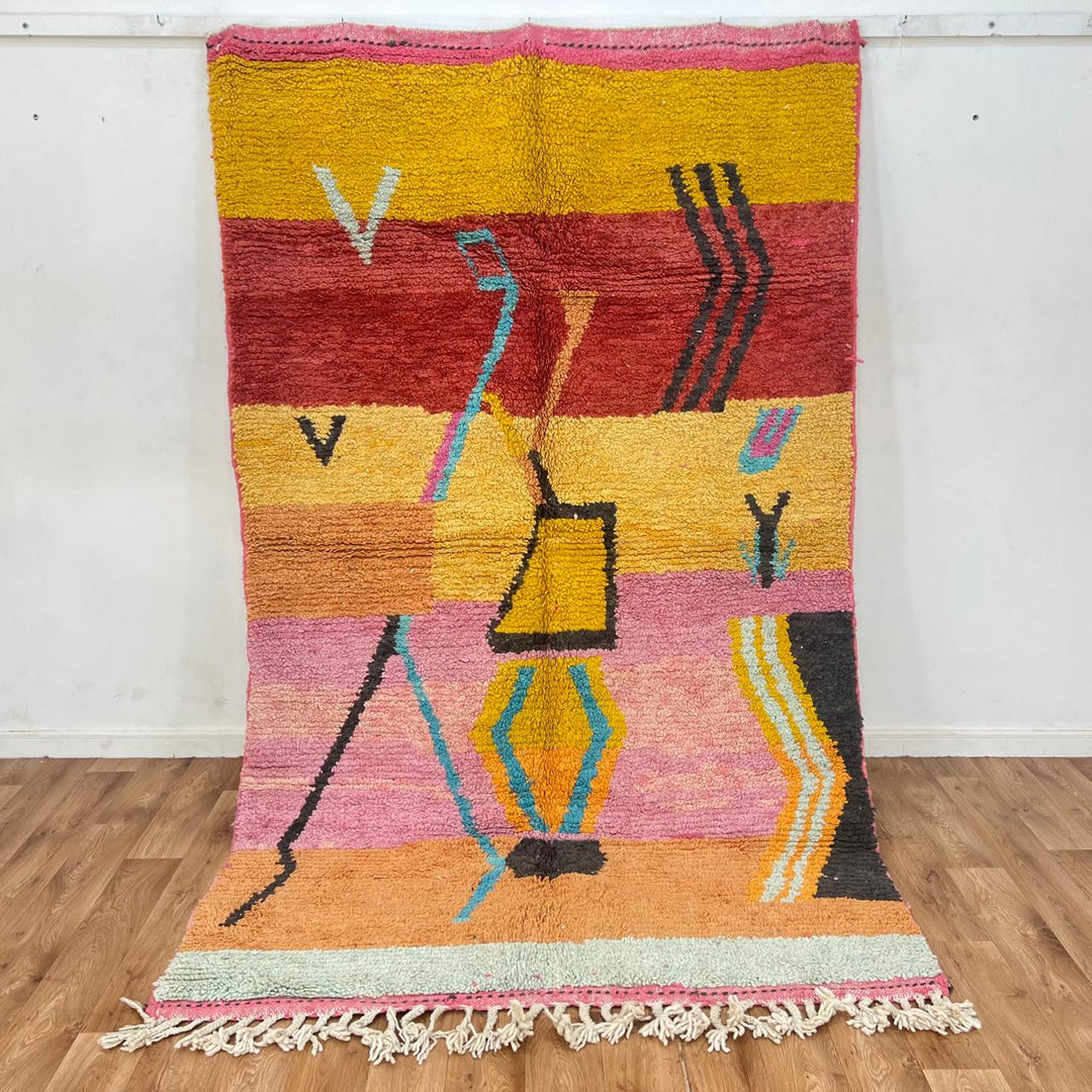 Vintage Moroccan wool rug with abstract Berber tribal symbols in mustard, terracotta and blush pink, handmade in Morocco.