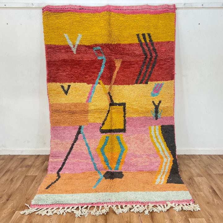 Vintage Moroccan wool rug with abstract Berber tribal symbols in mustard, terracotta and blush pink, handmade in Morocco.