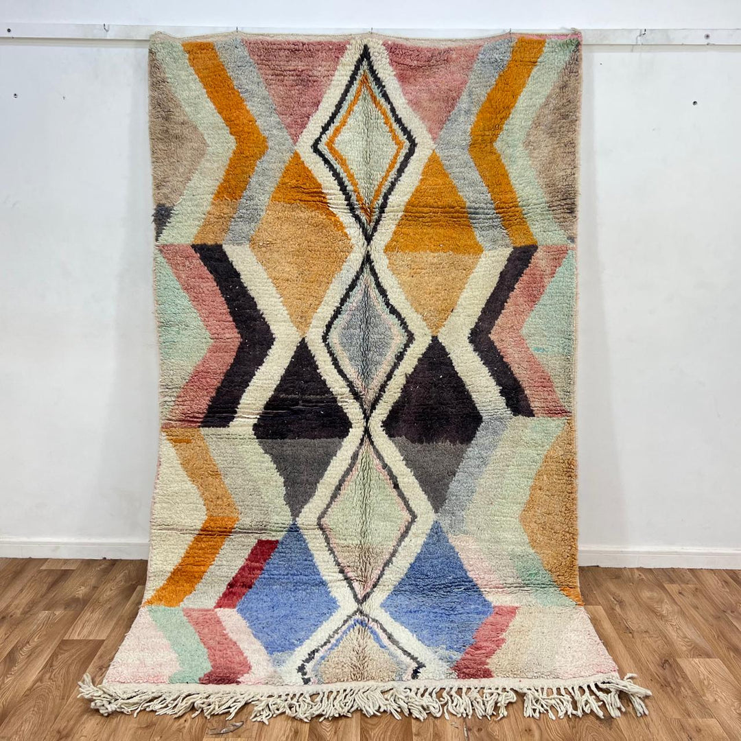 Vintage Moroccan wool rug with geometric diamond pattern in beige, orange, pink, blue and black, handwoven Berber carpet 251x157 cm